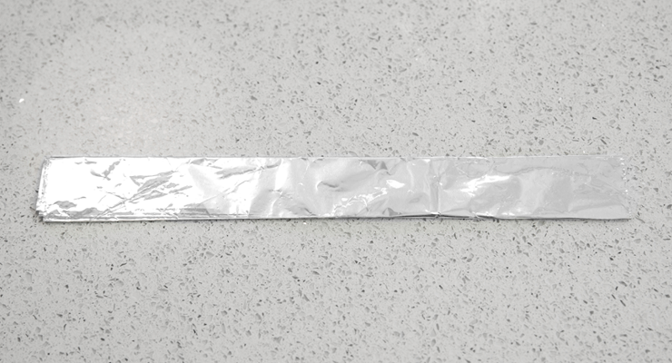 A sheet of foil rolled into a long, thin shape