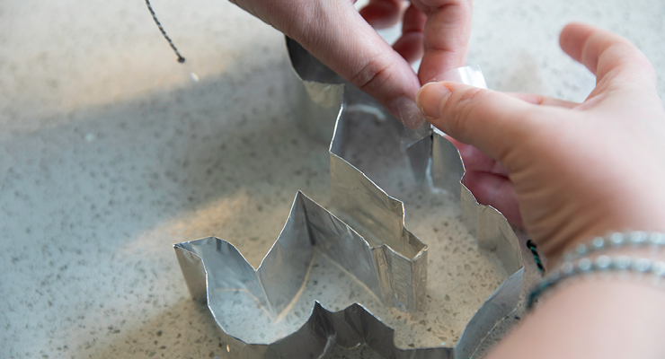 The cookie cutter ends are fastened with tape to complete the shape