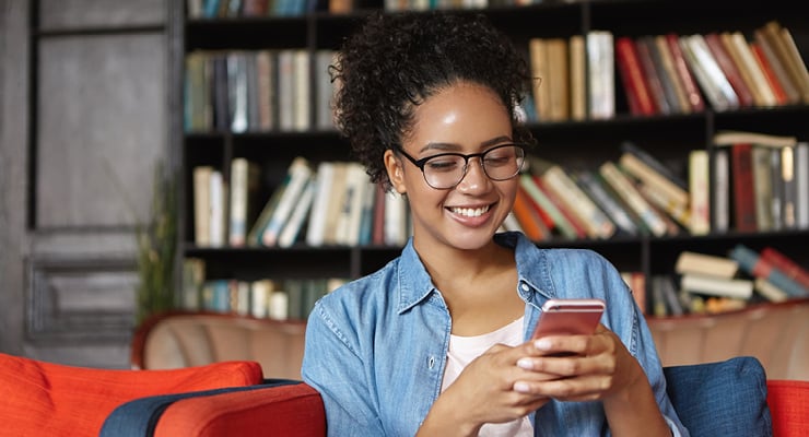 Female student downloading college prep apps on her phone as she gets ready for college.