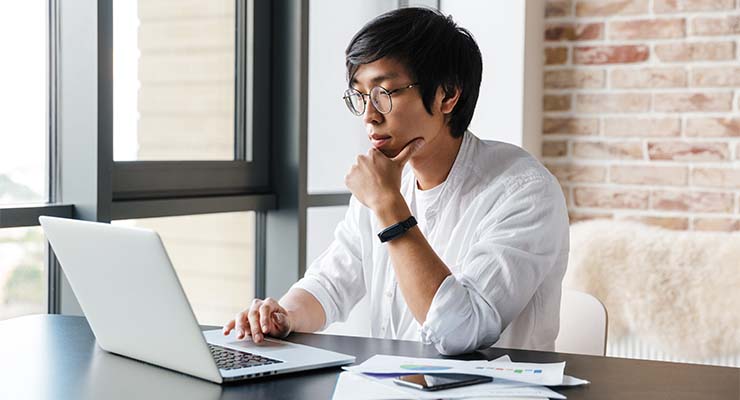 Male high school student conducting research about how to choose a college major for the career they want.