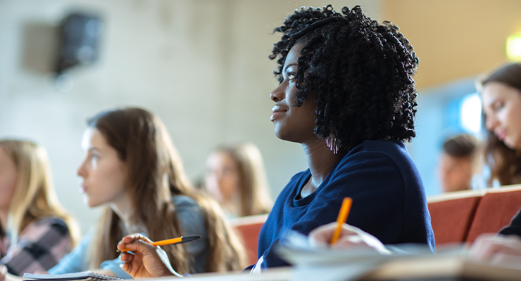 A group of students sitting a classroom learning about non-degree and degree-seeking programs.