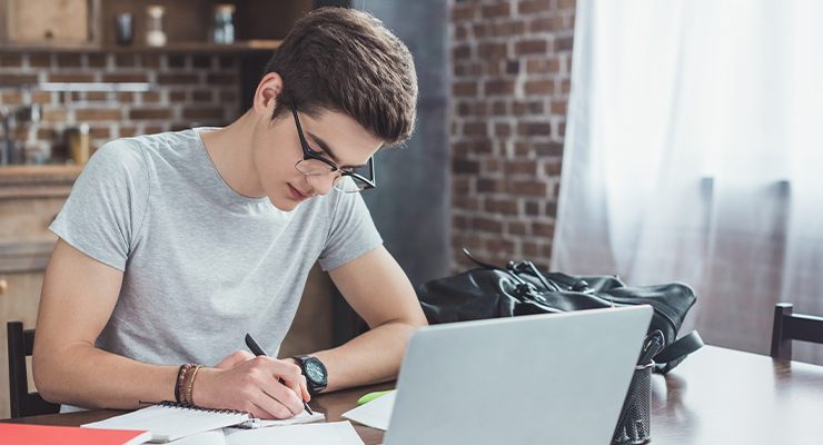 Male transient student filling out an application to take classes at another university.