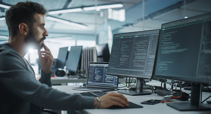 A male professional working a lucrative career on his computer at work.