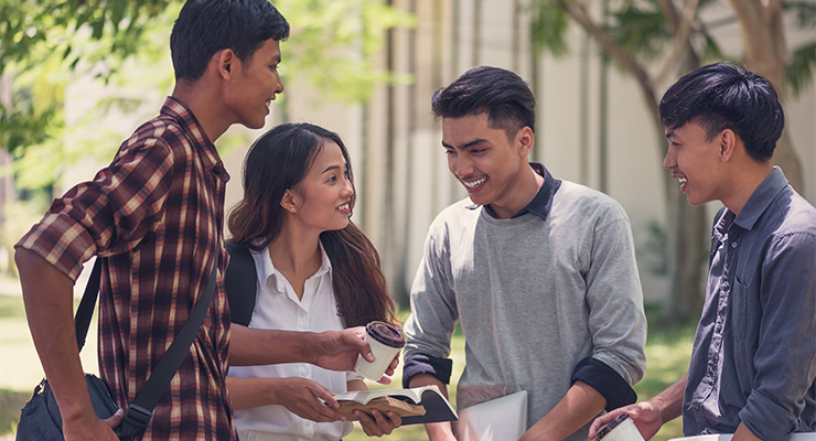 Group of students laughing and talking reflecting the campus diversity at that college.