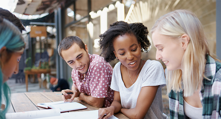 A group of students sitting outside together.