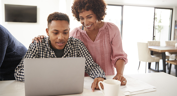 Mother and son calculating expenses to make a college decision.