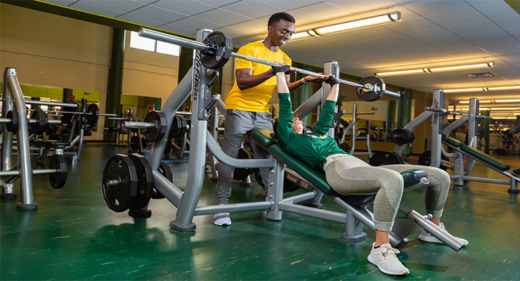Two USF students working out at the recreation center on campus.