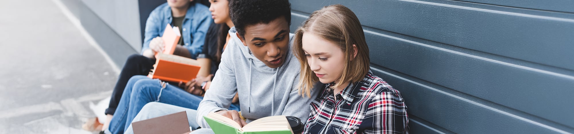 A group of young teens discussing the books they've been reading. A group of young teens discussing the books they've been reading.