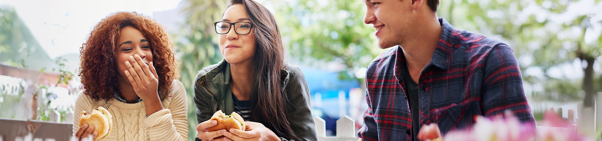 Three students eating together.