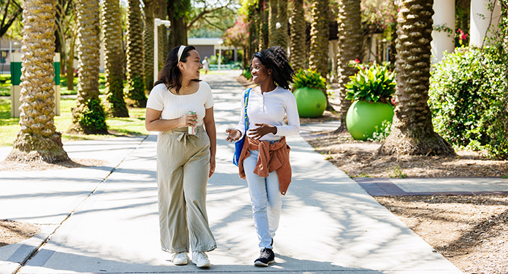Two USF students walking together on campus.