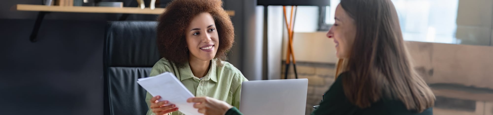 A student talking to her professor during office hours. A student talking to her professor during office hours.