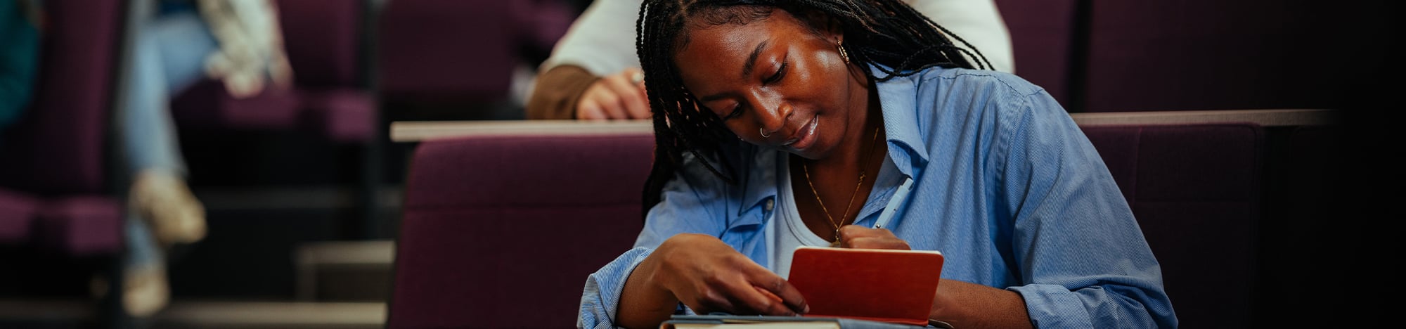 A student taking notes in class.