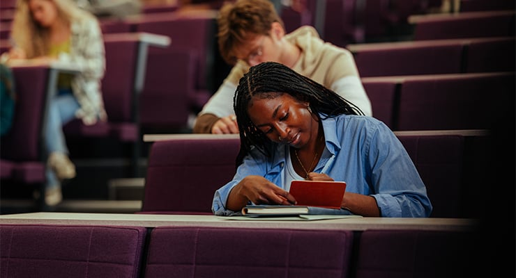 A student taking notes in class.