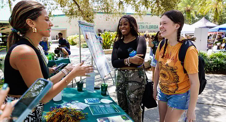 Students talking to each other on campus during an on campus event.