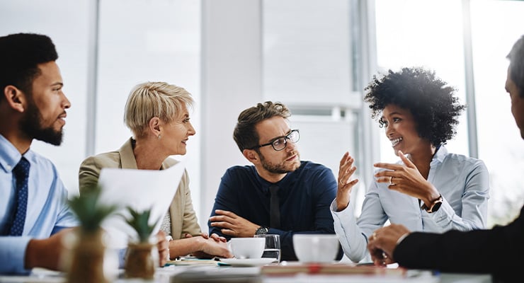 A group of employees having a discussion during a meeting.