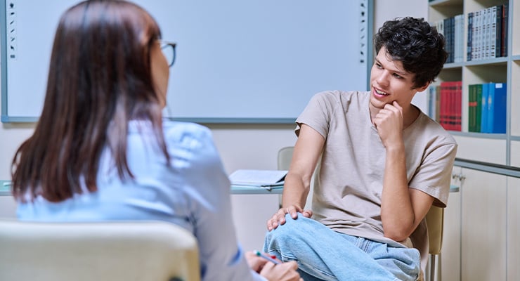 A student meeting with his high school counselor.
