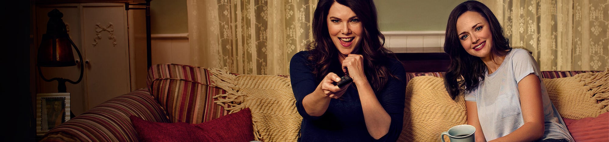 Lorelai Gilmore and Rory Gilmore sitting on a couch Lorelai Gilmore and Rory Gilmore sitting on a couch