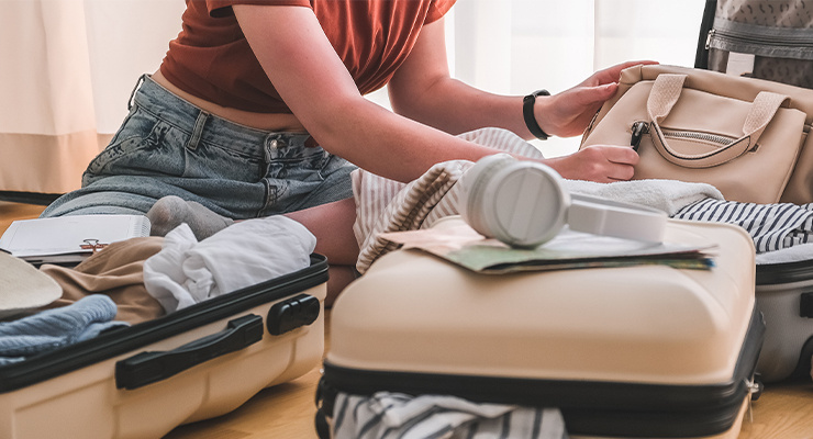 A woman packing her suitcases for a trip.