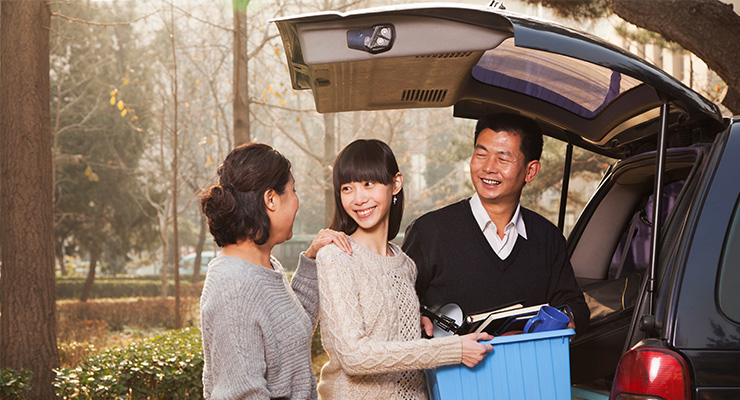 Mother and father saying goodbye to their daughter because she's moving for college.