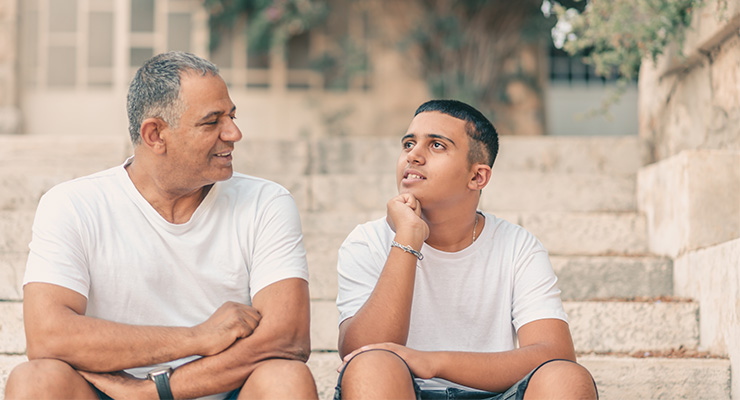 Father and son having a conversation and planning for college.