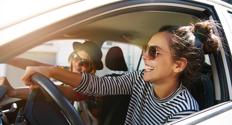 Two students driving around in a car.