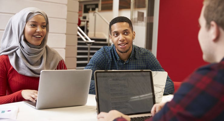 Two students and a counselor discuss college priorities and questions.