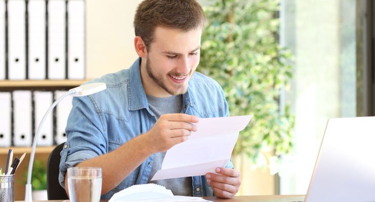 High school student reads a college decision letter.