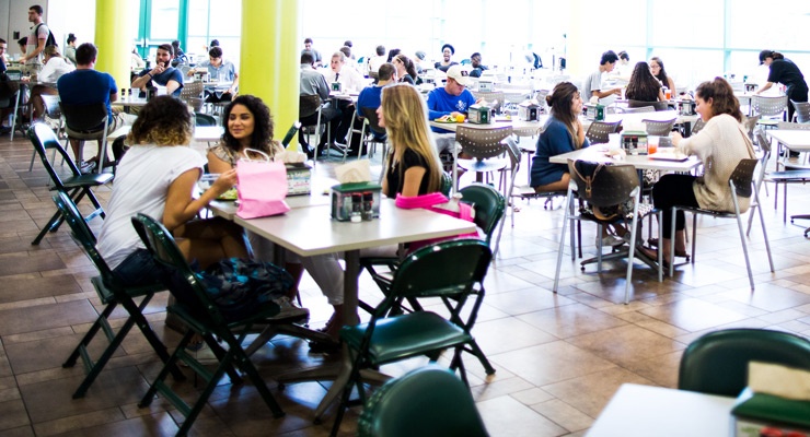 USF students hanging out, talking, and eating in a USF dining hall.