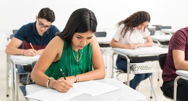 Four students take the ACT exam in a classroom