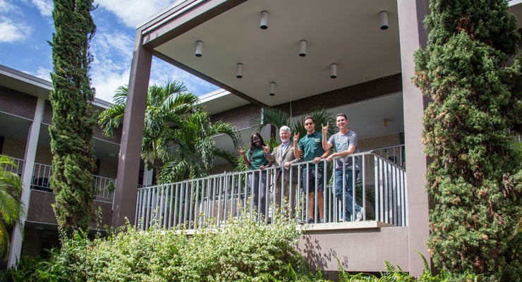 USF Honors College students and the Honors College Dean in the courtyard at the Honors College building