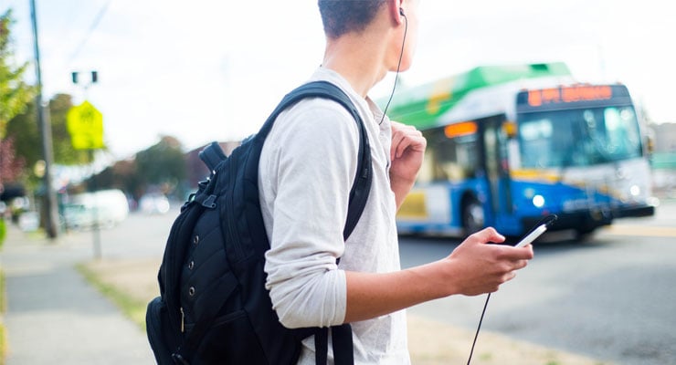 College student waiting for the bus.