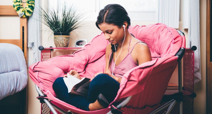 USF student studying in her room on campus.