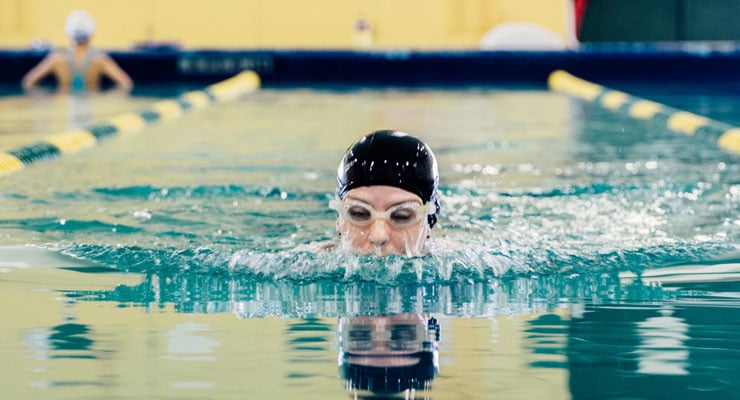 USF student swimming in the pool.