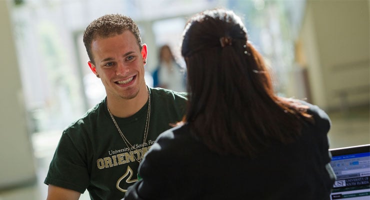 USF Orientation team member talking to a new USF student during orientation.