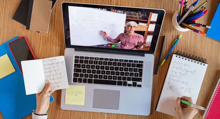 An overhead view of a professor teaching a remote learning course on a student's laptop