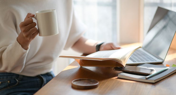 a student makes studying fun by enjoying coffee while learning