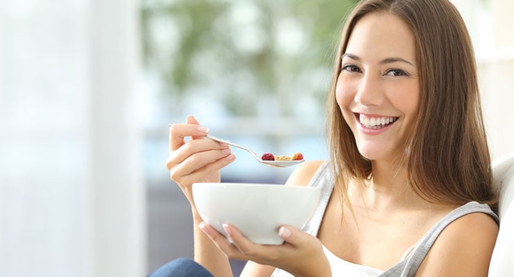 female student rewards herself with a snack for managing time effectively 