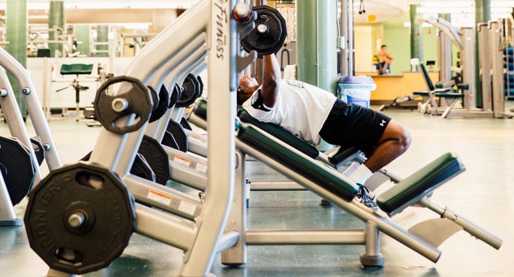 USF students practicing stress relief techniques by working out in the gym.
