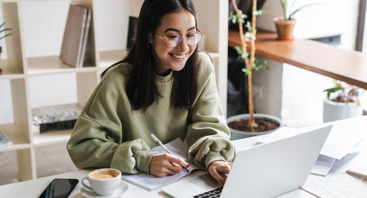 A student reviews her finances on a laptop and decides if she is ready for college.