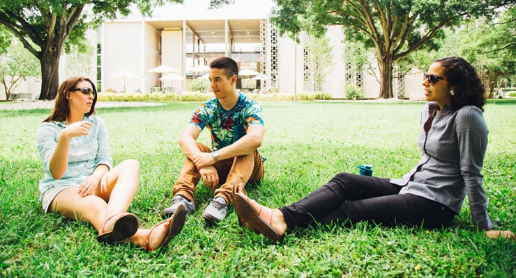 USF students sitting outside talking about school.