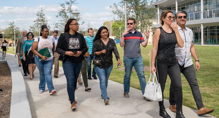 Students and parents asking questions on a campus tour at USF