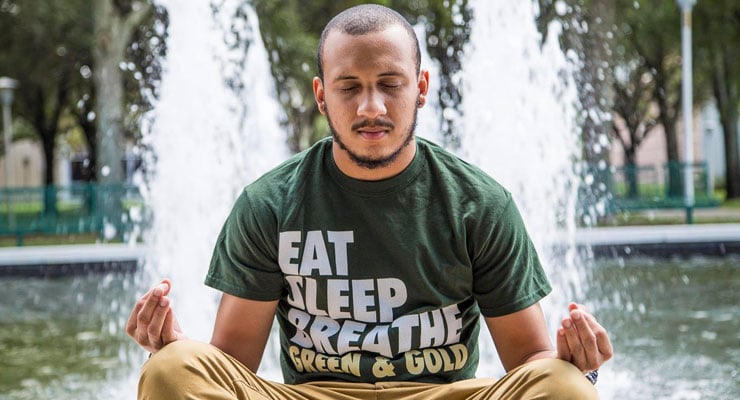 USF student enjoying a meditation at the MLK Plaza on campus.