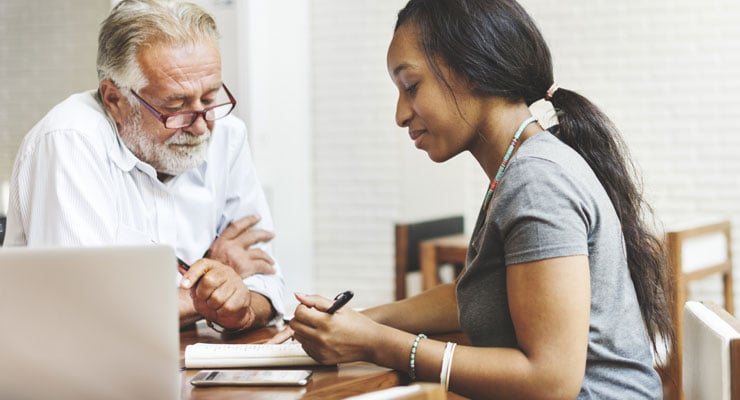 Counselor helping a student with college applications