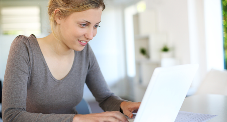 Woman looking up college scholarships on the computer