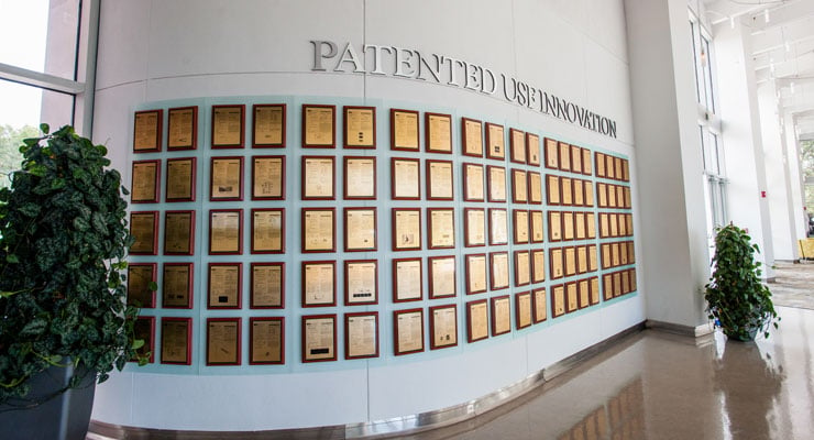 The USF Research & Innovation wall of patents recognizing research breakthroughs