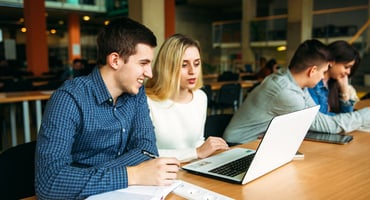 Students work on an assignment in the library together
