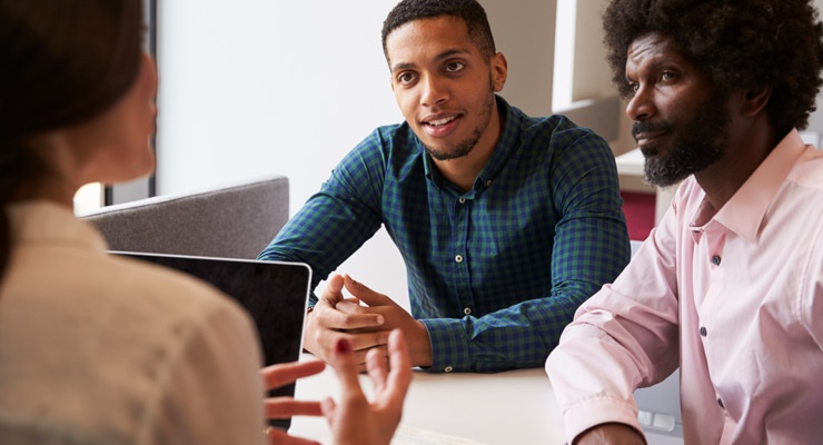 High school student and parent talking with a college counselor. High school student and parent talking with a college counselor.