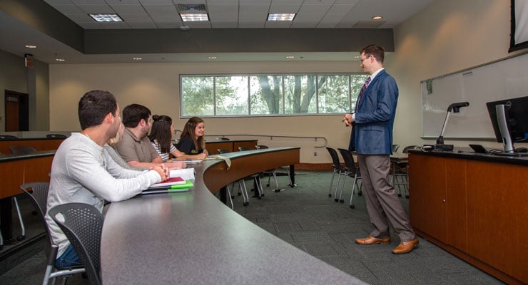 USF students in a small class have an in-depth discussion about the lesson with the teacher.