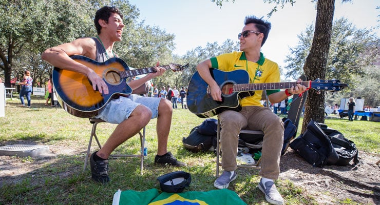 Two USF students play guitars and sing during a multicultural event.