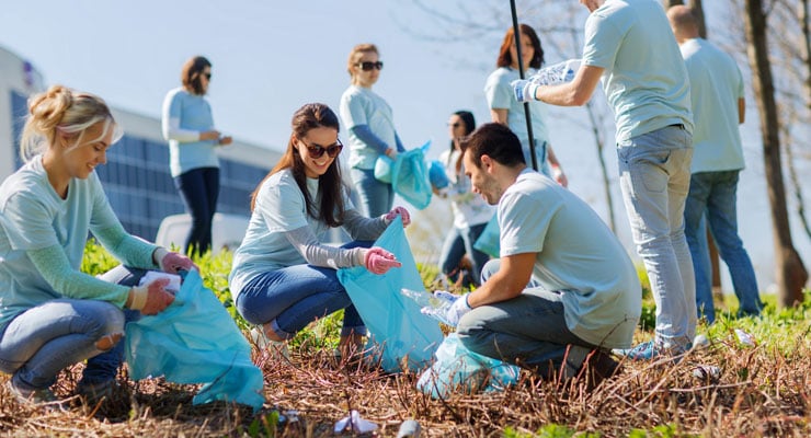 Students volunteer their time to clean up a park.